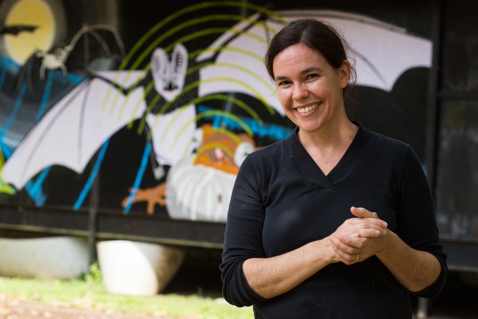 Rachel Page, staff scientist, standing in front of Damond Kyllo’s bat mural at the Smithsonian Tropical Research Institute’s Gamboa